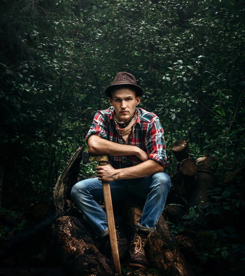 stylish-hipster-lumberjack-with-ax-in-the-sunny-fo-68HK3E8-1.jpg